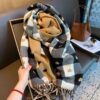 Soft oversized plaid scarf with checkered pattern, decorative motifs, and fringed edges